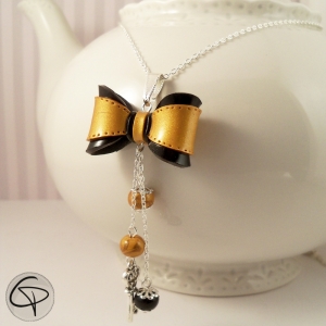 Pendentif nœud doré noir élégant femme