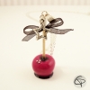 Sautoir pomme d'amour fuchsia avec nœud ruban noir
