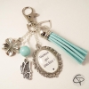 Bijou de sac pompon bleu pastel papillon fleur et coeur