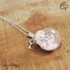 pendentif globe en verre contenant une étoile batonnets sucre d'orge et neige